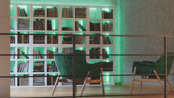 LED Strip System Kategorie Value Das Bild zeigt eine Sitzecke mit grünen Sesseln und einem mit grünem Licht beleuchteten Bücherregal.