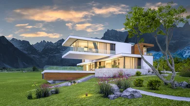 Ein modernes, mehrstöckiges Wohnhaus mit großen Glasflächen in einer grünen Landschaft vor einer Bergkulisse bei Abendlicht.