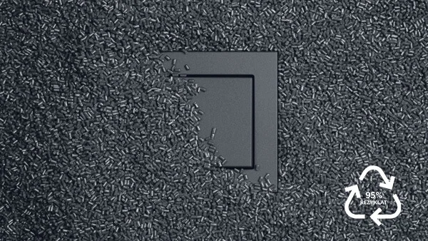 Schalter in der Farbe Grau des Herstellers Jung. Der Schalter ist mit feinen grauen Körnern zur Hälfte bedeckt.