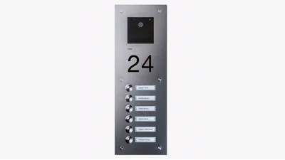 Das Bild zeigt eine längliche, moderne Türsprechanlage aus Edelstahl mit Kamera, Hausnummer 24, sechs Klingelknöpfen und Namensschildern.