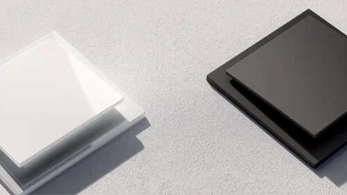 Das Bild zeigt einen schwarzen und einen weißen Lichtschalter der Serie Busch-art linear®, die über Eck auf einem grauen Untergrund liegen.