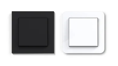 Das Bild zeigt einen weißen und einen schwarzen Schalter nebeneinander. 