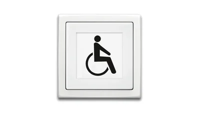 Das Bild zeigt ein weißes Busch-Infolicht mit schwarz aufgedrucktem Rollstuhl-Symbol vor weißem Hintergrund.