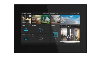 Das Bild zeigt ein schwarzes Busch-OneTouch 7"vor weißem Hintergrund. Auf dem Display des Panel sind verschiedene Bedienungsfunktionen abgebildet.
