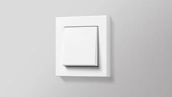 Schalter in der Farbe Weiß des Herstellers Jung an der grauen Wand montiert.
