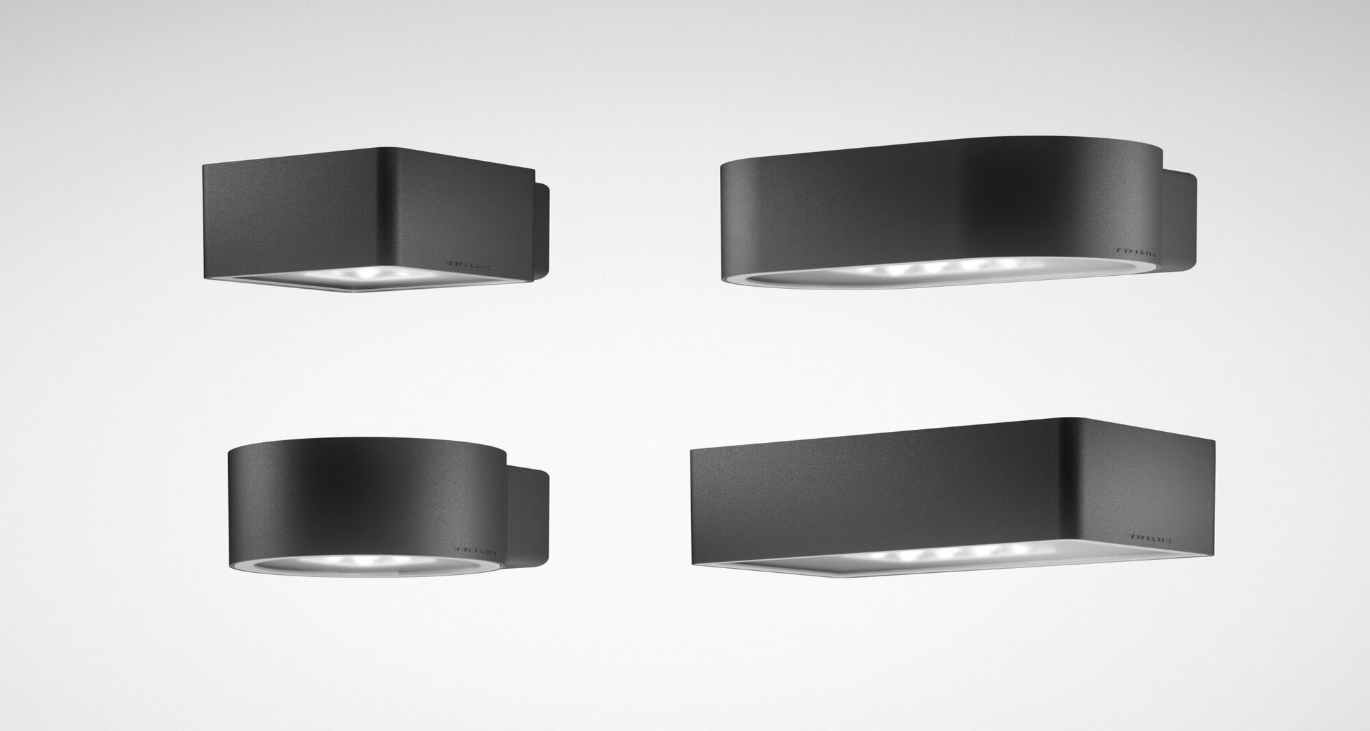 Das Bild zeigt vier moderne, dunkelgraue Wandleuchten mit unterschiedlichen Gehäuseformen – zwei rechteckige und zwei runde Varianten – vor einem hellgrauen Hintergrund.